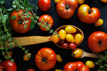 Fresh tomatoes on a dark concrete background