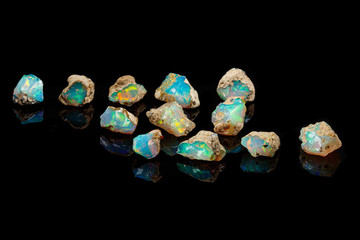 macro mineral stone rare and beautiful opals on a black background
