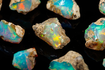 macro mineral stone rare and beautiful opals on a black background