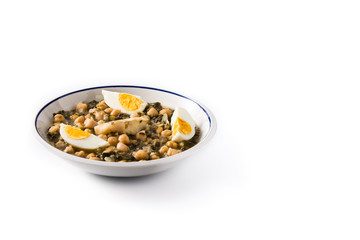 Fototapeta na wymiar Chickpea stew with spinach and cod or potaje de vigilia isolated on white background. Copy space