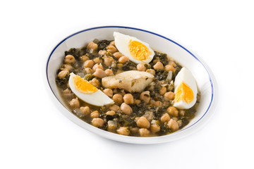 Chickpea stew with spinach and cod or potaje de vigilia isolated on white background