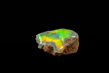 macro mineral stone rare and beautiful opals on a black background