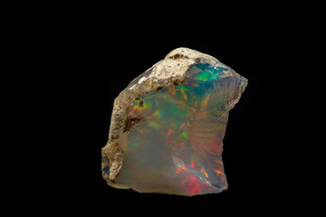 macro mineral stone rare and beautiful opals on a black background