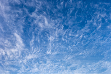 Beautiful spindrift clouds on a blue autumn sky in a frosty day.	