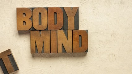 body, mind, soul and spirit - stop motion animation of words in vintage wood letterpress printing blocks against textured paper, holistic wellness and lifestyle concept