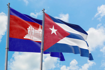 Cuba and Cambodia flags waving in the wind against white cloudy blue sky together. Diplomacy...