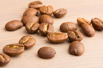 coffee beans. the pile on wooden table. close up