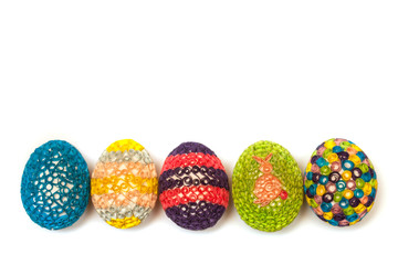 Row of five colorful quilled Easter eggs on white background. Easter symbol, holiday, celebration, springtime