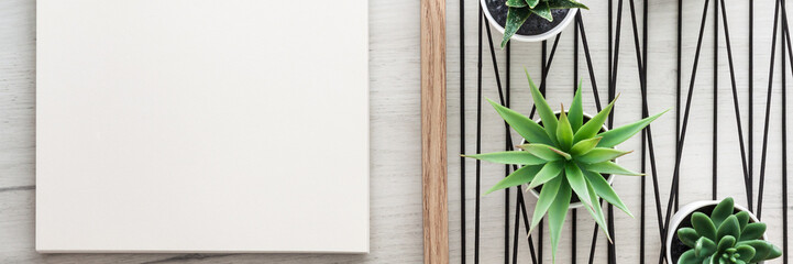 Wooden white desk with a wooden frame with succulents. Mockup. Copy space. Office notebook. Scandinavian style. Panoramic photo