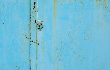 old blue metal door with a hole