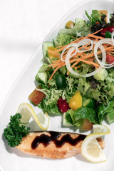organic mixed vegetable salad with salmon fillet and balsamic vinaigrette
