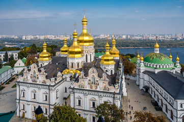 Fototapeta na wymiar Part of Pechersk Lavra monastery complex in Kiev (Ukraine) reconstructed Cathedral of the Dormition seen from the Great Lavra Belltower in late summer with Dnipro river behind