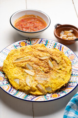Spanish scrambled eggs with potatoes called tortilla or tapa on white background