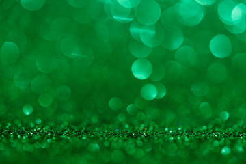Obraz premium Abstract fresh green background with bokeh effect. Blurry shiny shimmer sequins