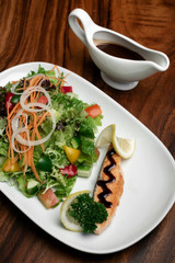 organic mixed vegetable salad with salmon fillet and balsamic vinaigrette