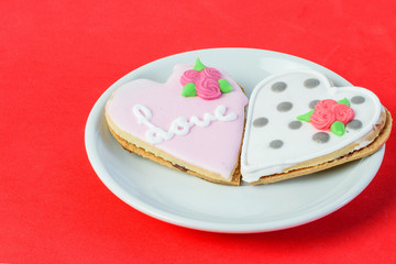 Greeting card for Sant Valentines day. Sweet cakes in a form of hearts as a symbol of all the lovers.