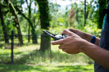 Man handling a drone remote controller 