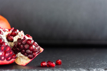 Fresh pomegranate broken on black background