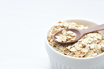 Natural oatmeal on light wooden background
