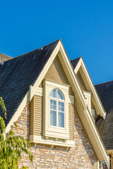 The roof of the house with nice window.