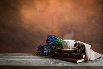 Vintage photo of books, coffee cup and lavander on a wooden table