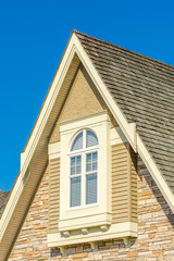 The roof of the house with nice window.