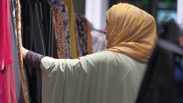 Muslim women with head scarf shopping indoor 
