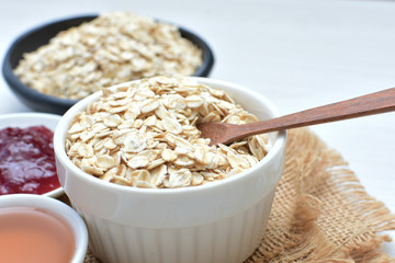 Natural oatmeal on light wooden background