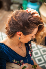 Woman and earrings made of natural stones. The mysticism of amulets. Esoterics in handmade jewelry close-up and copy space. Jewelry on the female neck.