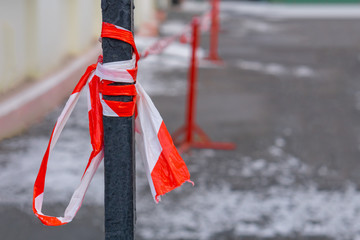 bounding red ribbon tied to a fence