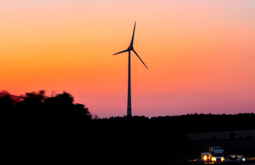 Windmills for electric power production  Wind turbines with power line in the sunset 