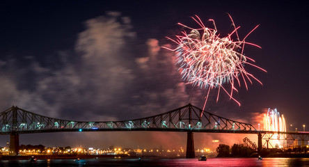 Photograph of fireworks. Jacques Cartier bridge with fireworks. Montreal Quebec. Fireworks.