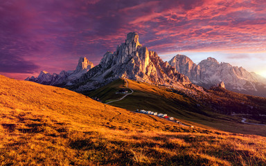 Amazing natural Landscape with colorful sky of Dolomites Alps during sunset. Passo Giau with famous...