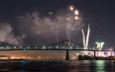 Fototapeta na wymiar Photograph of fireworks. Jacques Cartier bridge with fireworks. Montreal Quebec. Fireworks.