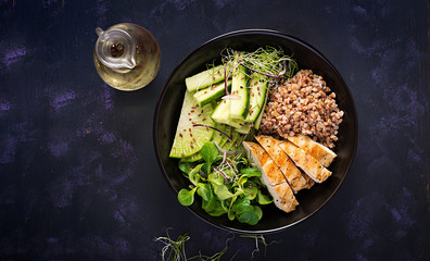 Lunch salad. Buddha bowl with buckwheat porridge, grilled chicken fillet, corn salad, microgreens and daikon. Healthy food. Top view, overhead