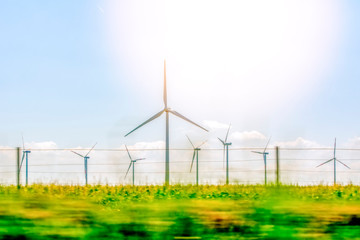 Windmills for electric power production  Wind turbines with power line in the sunset 