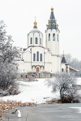 Beautiful white church near the lake in winter