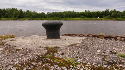 Rusty metal mooring bollard for a large ship. Anchorage on the Wharf for ships.