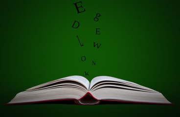 Open book with black letters going out