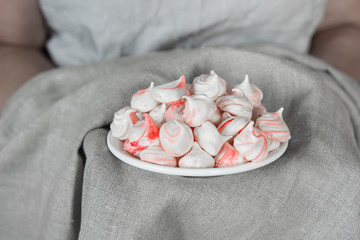 white-pink meringues on a plate