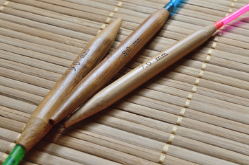 circular bamboo knitting needles on a wooden surface.