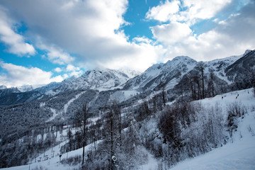 Fototapeta na wymiar mountain ski resort Rosa Khutor in Sochi. Winter sunny day with cloudy .