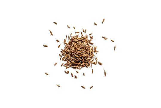 Top view of a pile of organic dry cumin seeds isolated on a white background