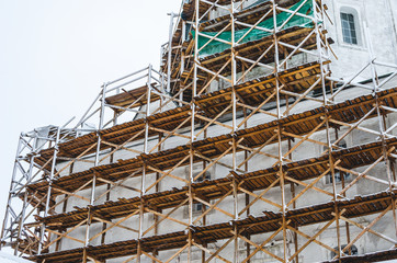 Spaso-Preobrazhenskaya Church is under restoration. Holy Assumption Monastery near Bryansk. Construction site scaffold in winter.