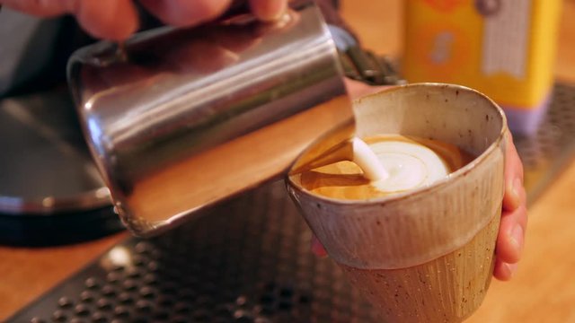 Close Up Of Barista Pouring Milk To Make Coffee Latte Art. 4K Slow Motion Footage. 
