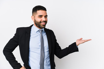 Young latin business woman against a white background isolated showing a copy space on a palm and...