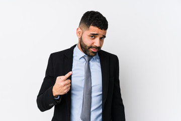 Young latin business woman against a white background isolated pointing with finger at you as if inviting come closer.
