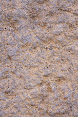 Grey and yellow shabby stone wall background. Top view