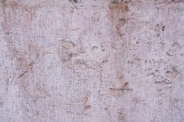 Old white shabby limestone wall texture background. Top view