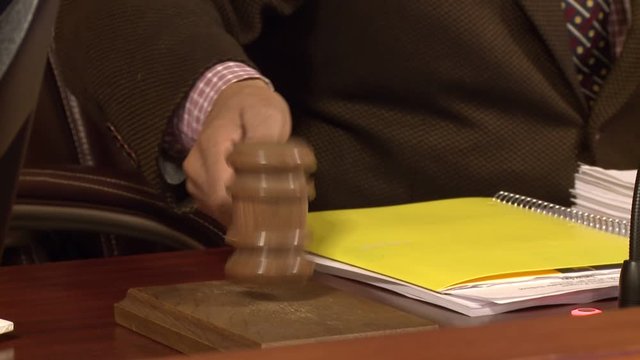Hesitant gavel hit on table